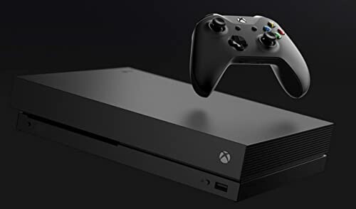 Xbox One X console with wireless controller on a dark background